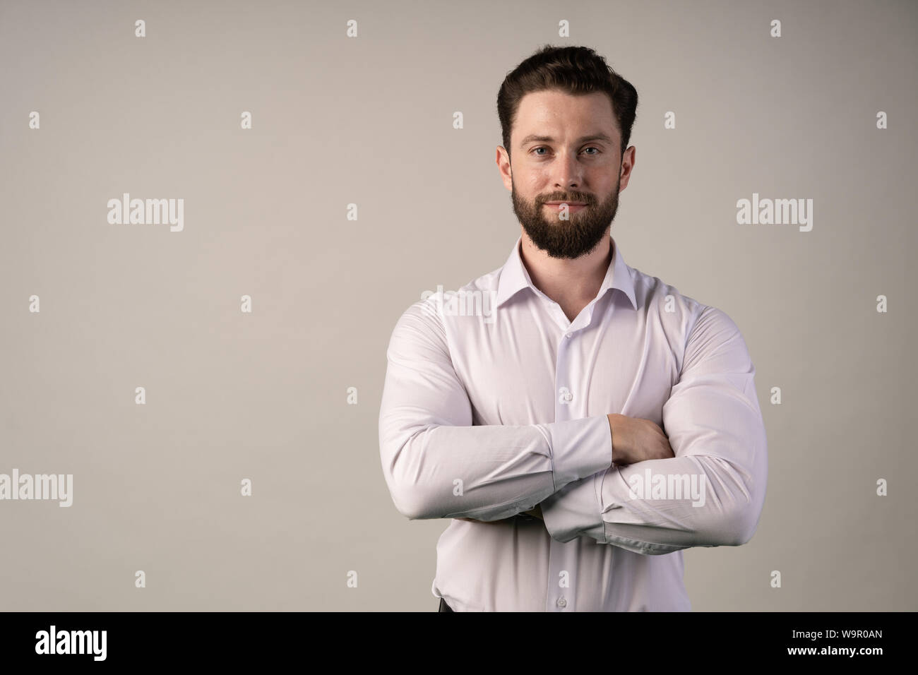 Man stands with his arms crossed . Concept stability, confidence