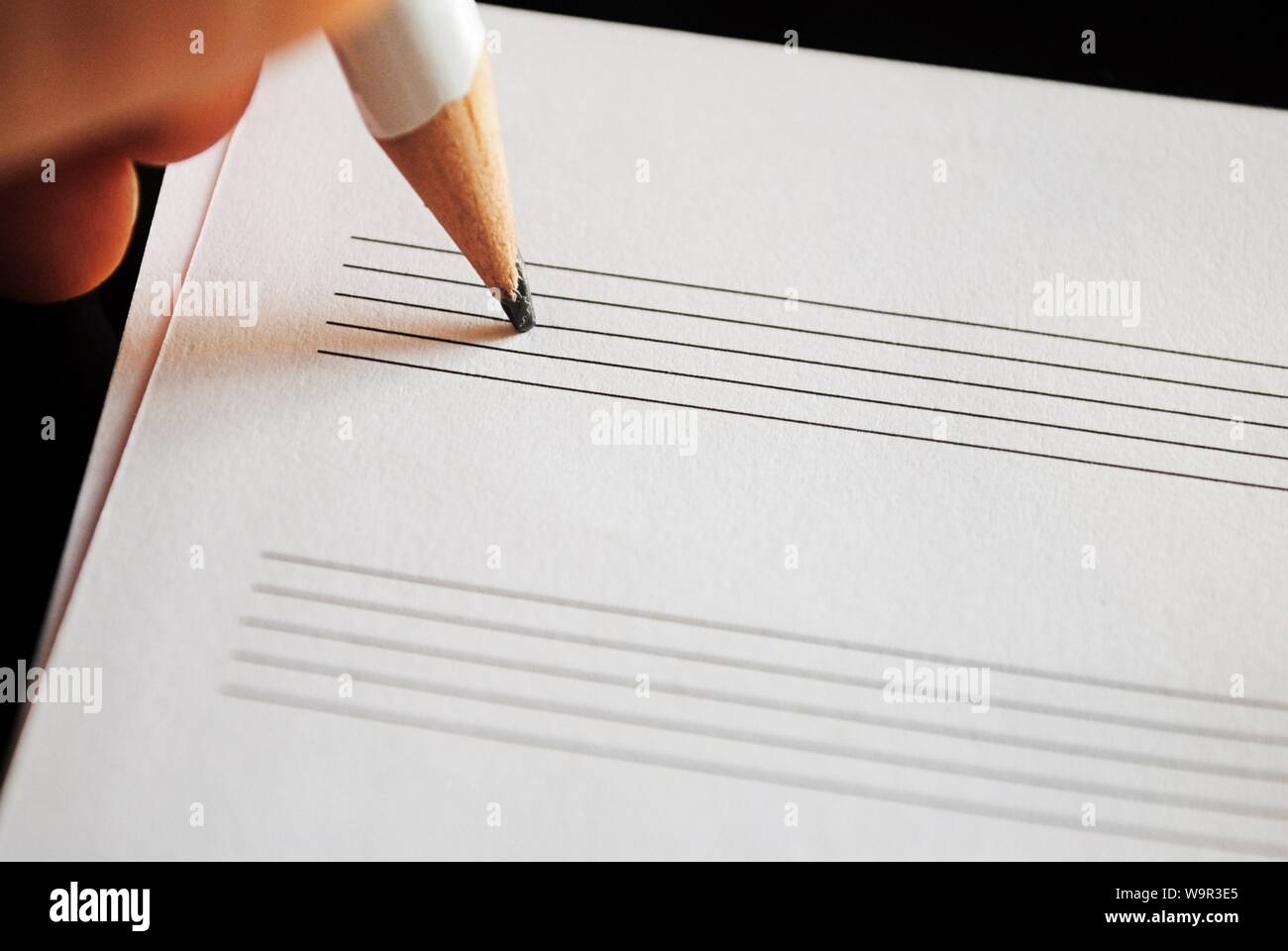 Composing music with a pencil and paper Stock Photo