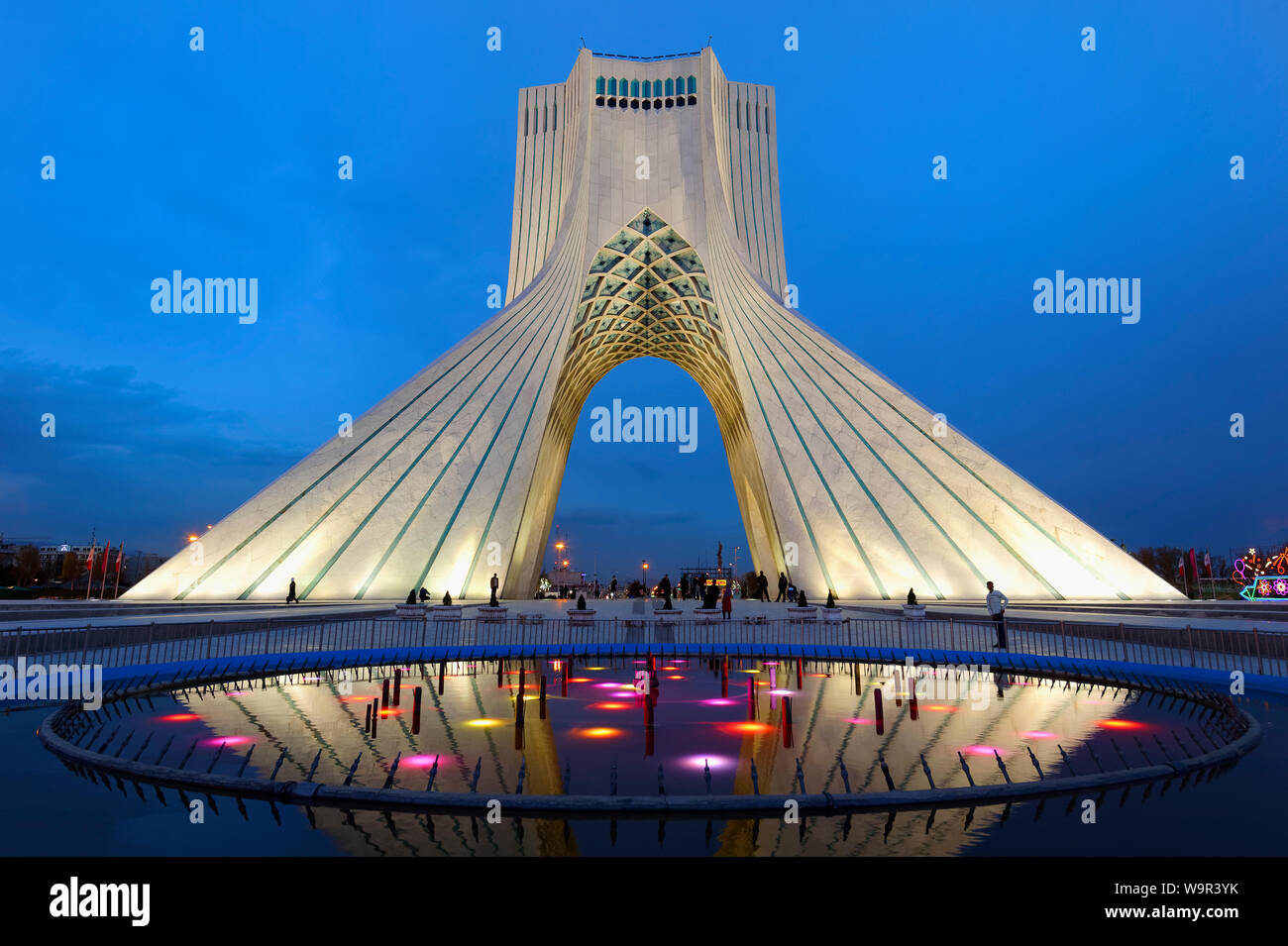 Azadi Tower or Borj-e Azadi tower or Freedom Monument formerly known as Shahyad Tower and cultural complex reflecting in a pond at sunset, Tehran, Isl Stock Photo
