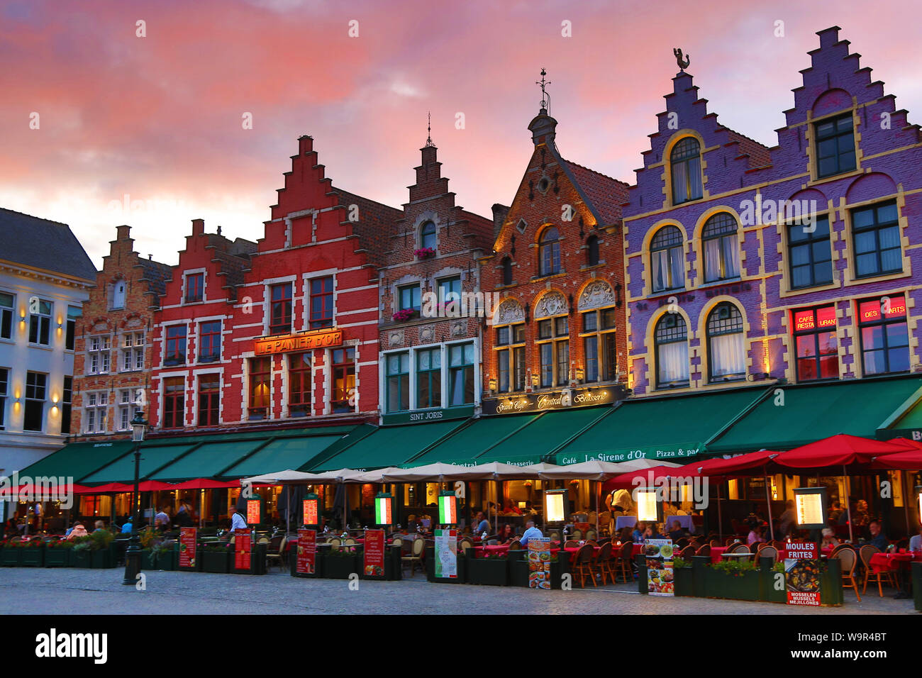 Guild houses converted into restaurants at sunset in the Market Square or Markt, Bruges, Belgium Stock Photo