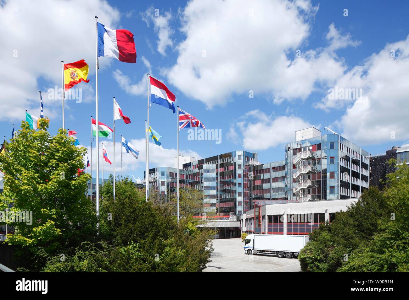 Waving international flags in front of the European Parliament, Konrad Adenauer Building, European District Kirchberg-Plateau, Luxembourg City Stock Photo