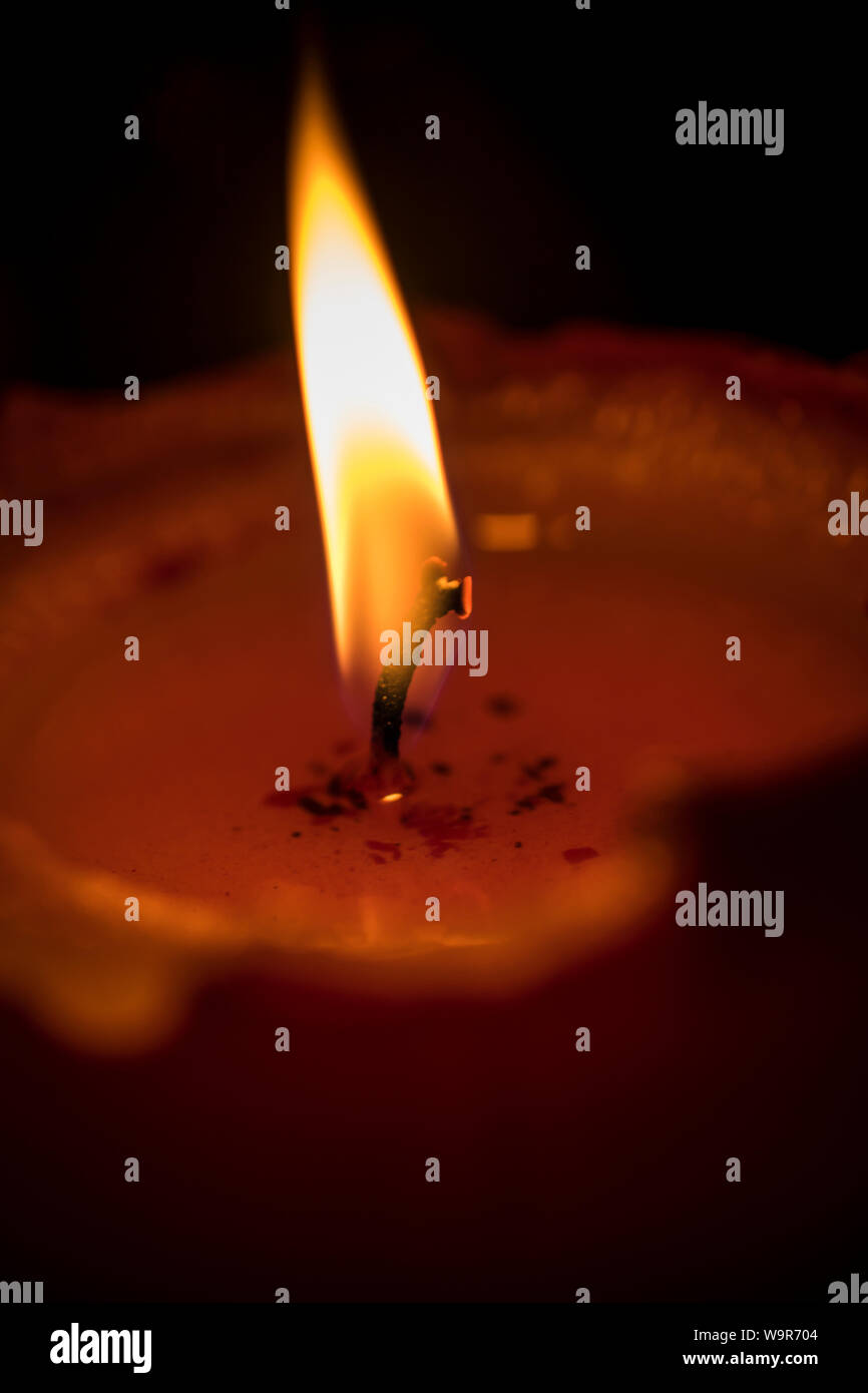 A closeup photo of a lit red candle Stock Photo Alamy