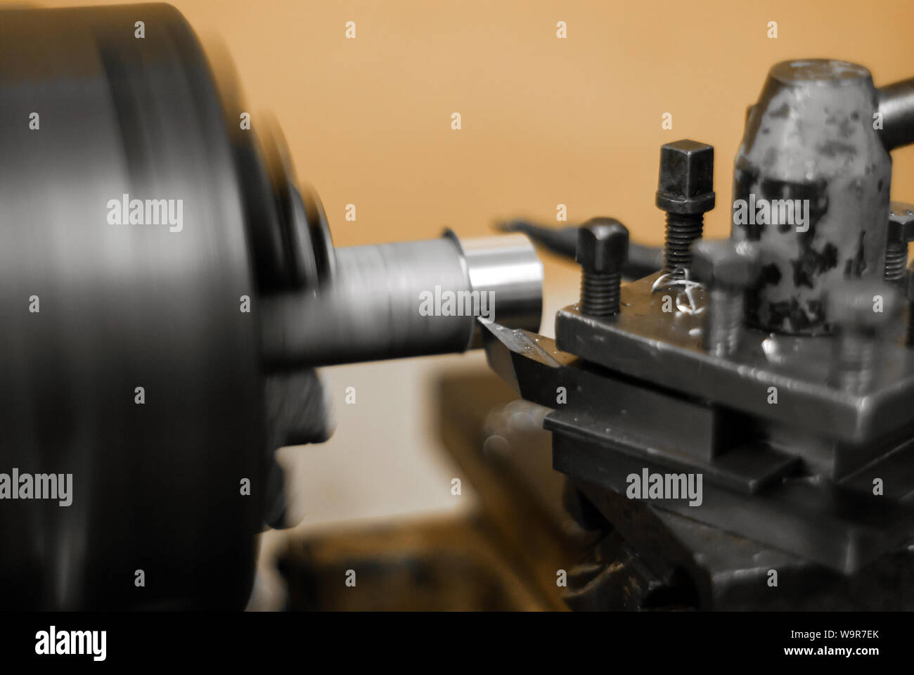 turning a rotating workpiece on a old manual metalworking lathe, focus