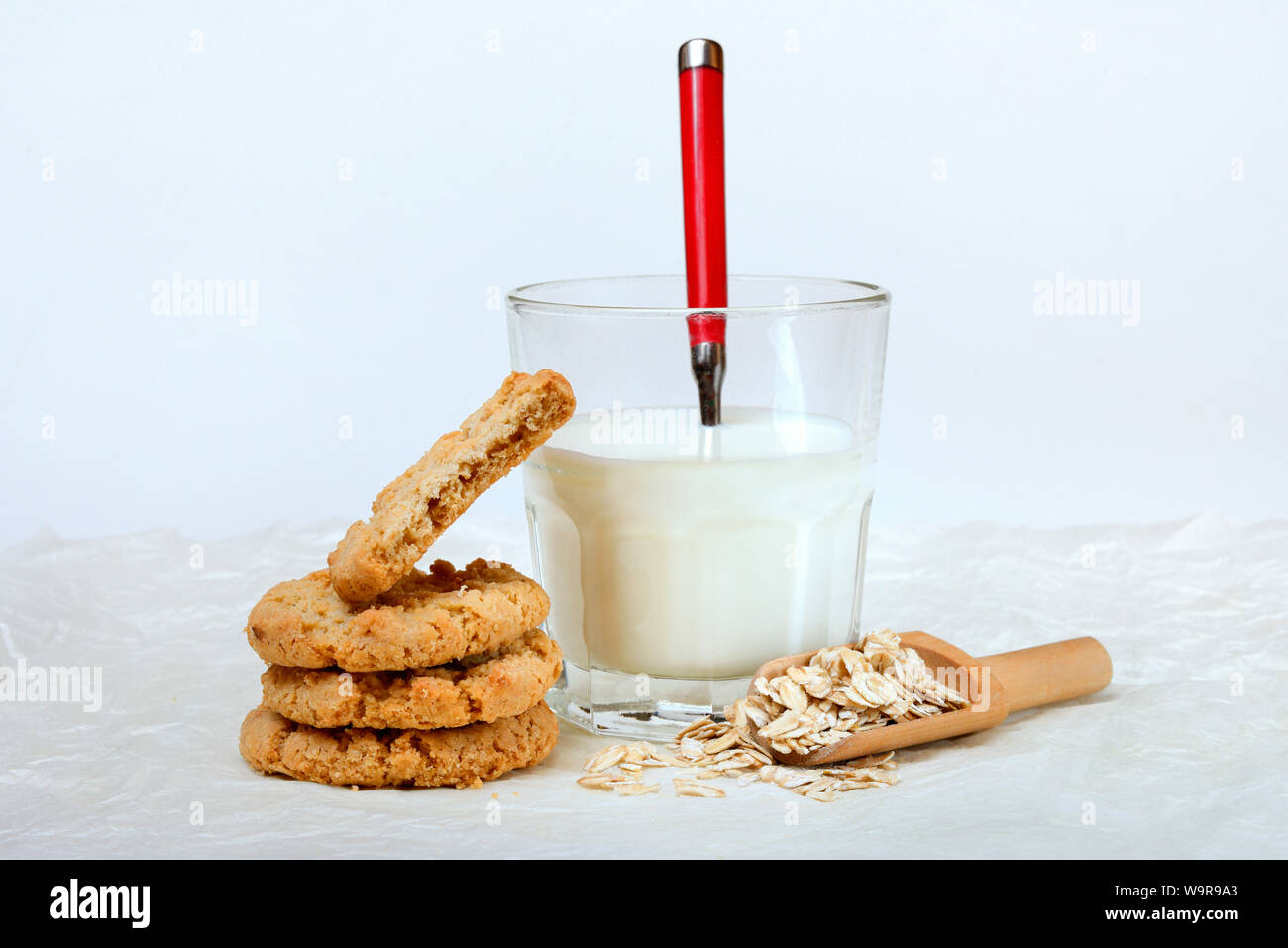 Oatmeal cookies, oat flakes and glass of milk Stock Photo