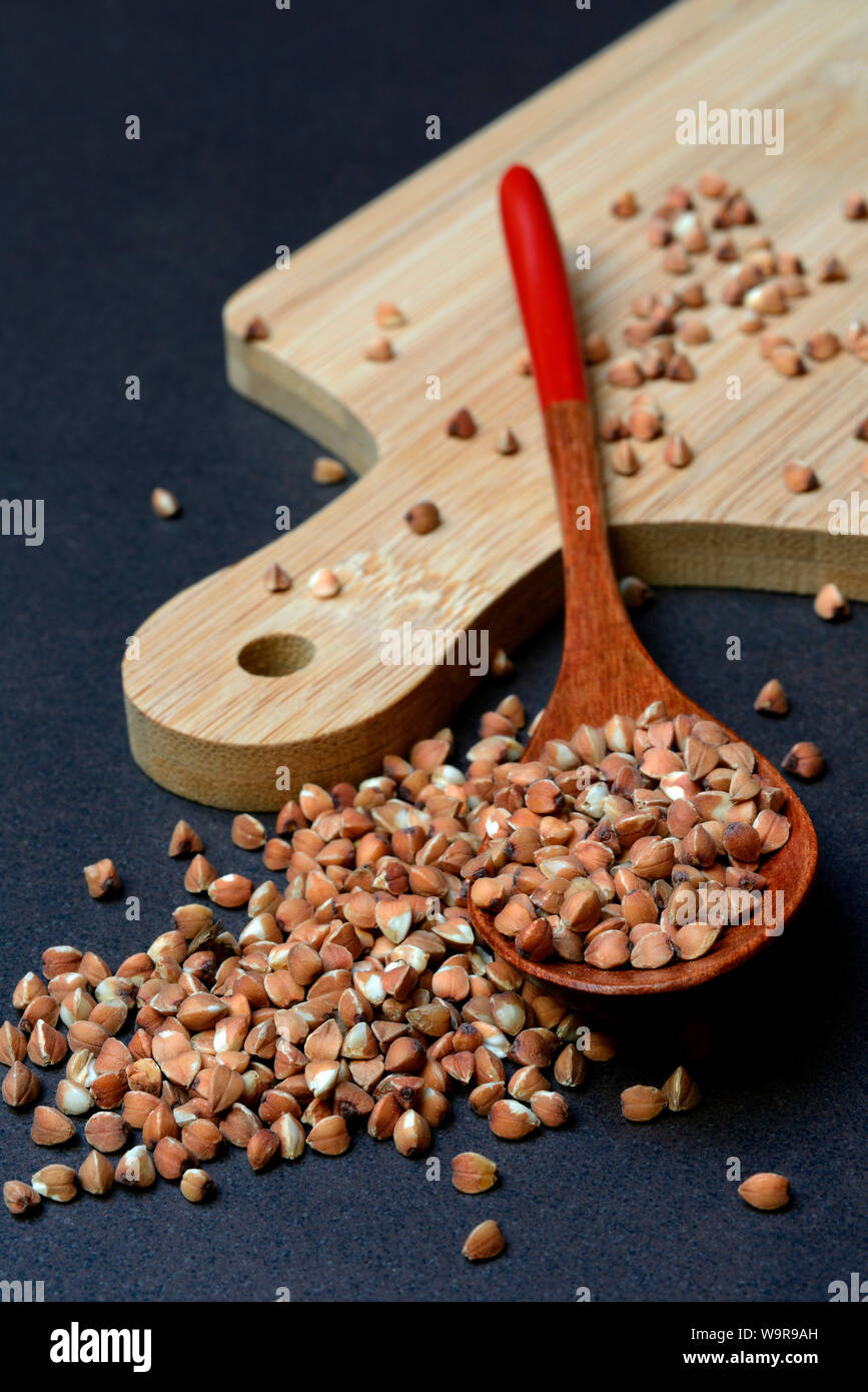 buckwheat in wooden spoon, Polygonum fagopyrum Stock Photo