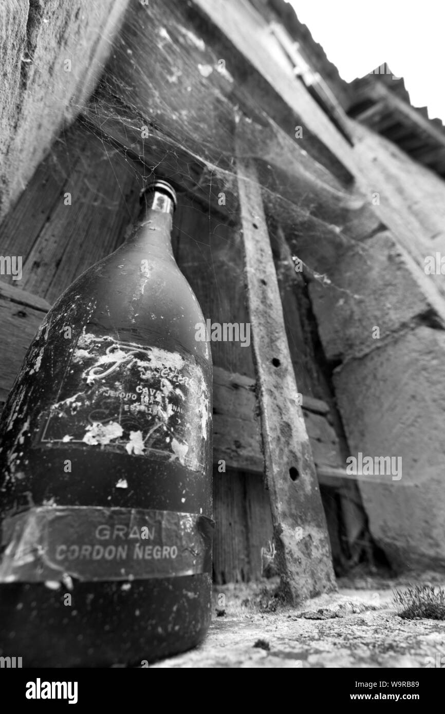 Village of Limeuil, France. Picturesque view of an empty wine bottle on the window sill of a derelict house. Stock Photo