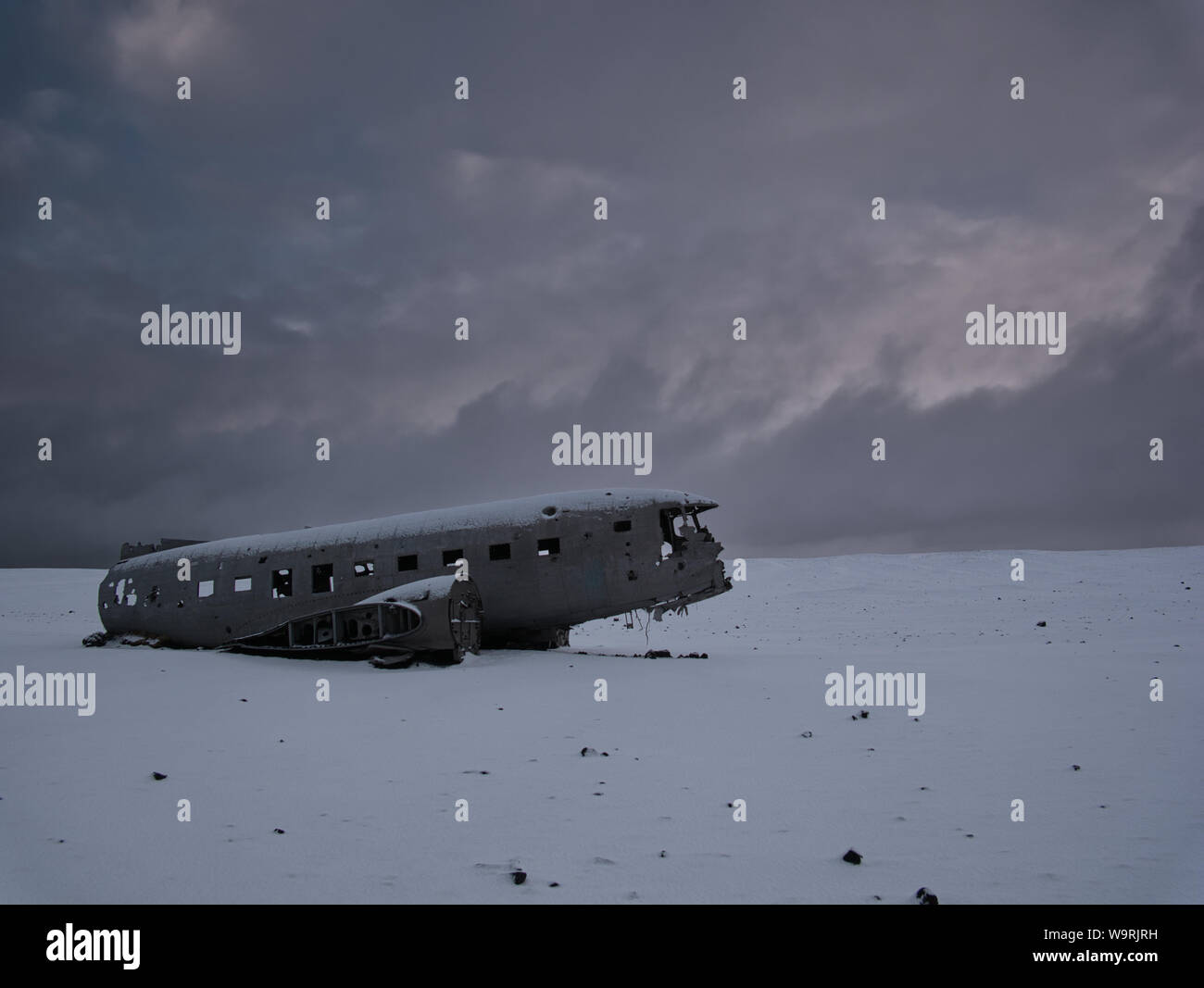 Crashed plane on a snowy field. Photo from March in Iceland Stock Photo