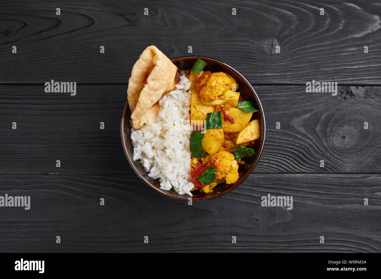 aloo gobi with rice and chapati. Indian cuisine vegetarian curry cooked