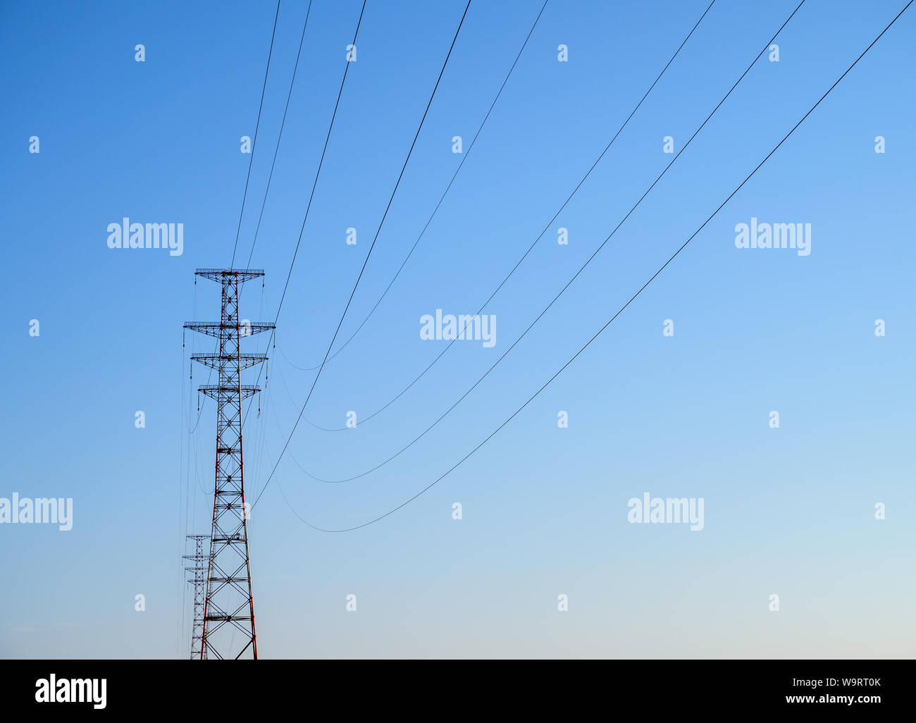 Hight-voltage electric power lines at sunset. Stock Photo