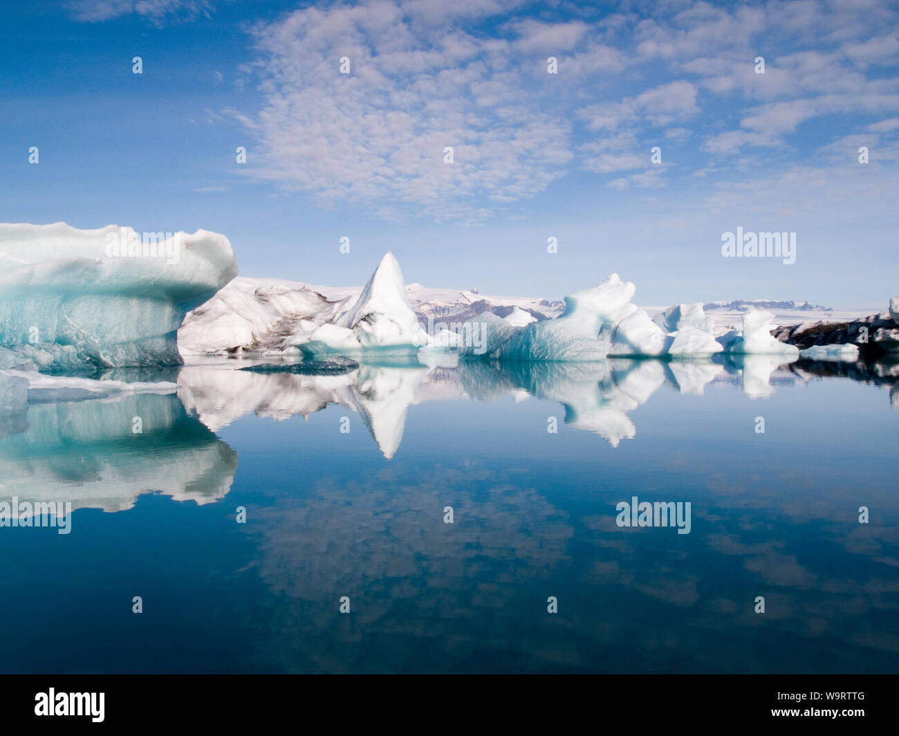 A group of floating iceburgs in a beautiful landscape under a blue sky. Stock Photo