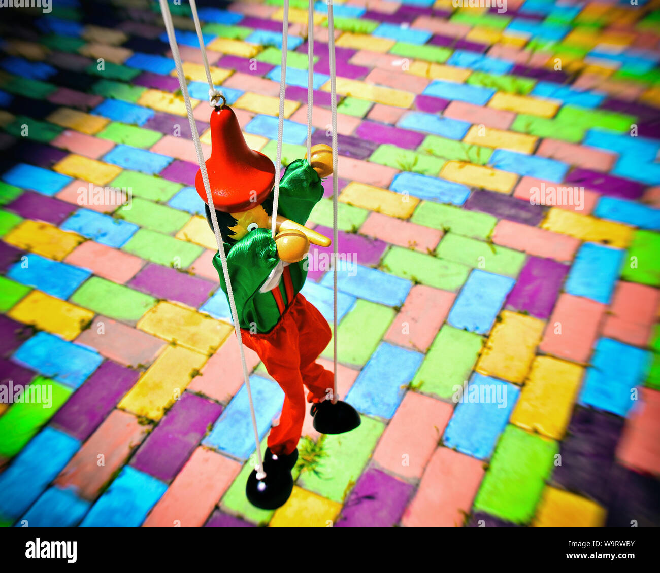 Old Wooden Pinocchio Puppet On A Colorful Tiles Marionette Retro Toy