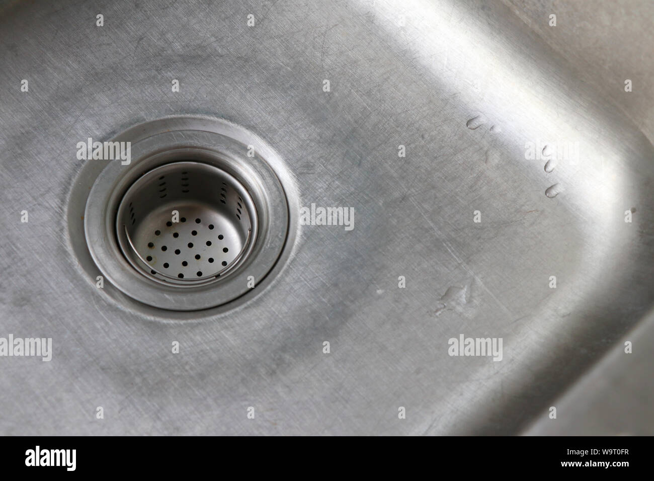 Drain in the sink. Drainage channel with food filter sieve. Stock Photo