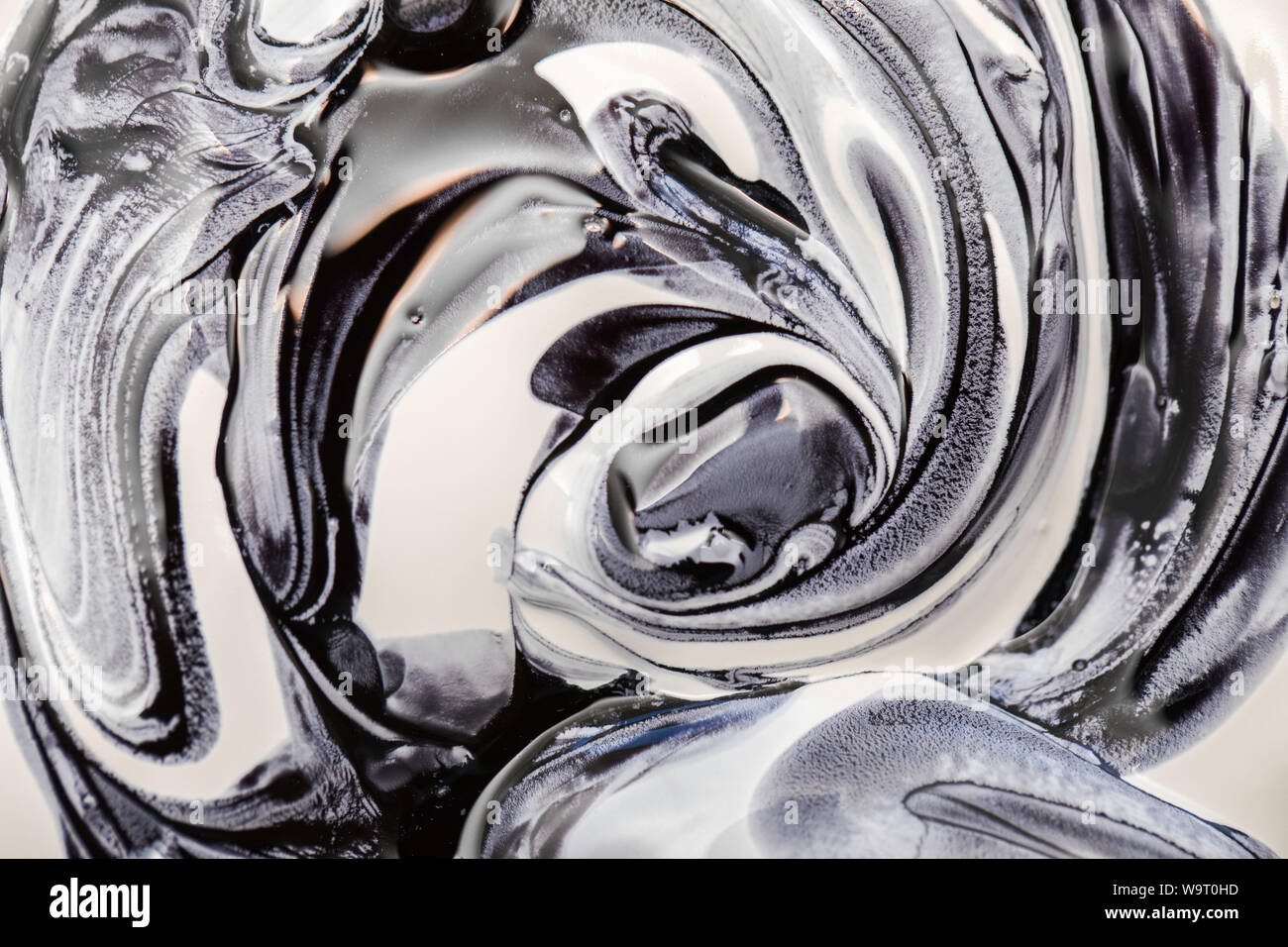 Mixing white and black paint, abstract pattern effect Stock Photo - Alamy