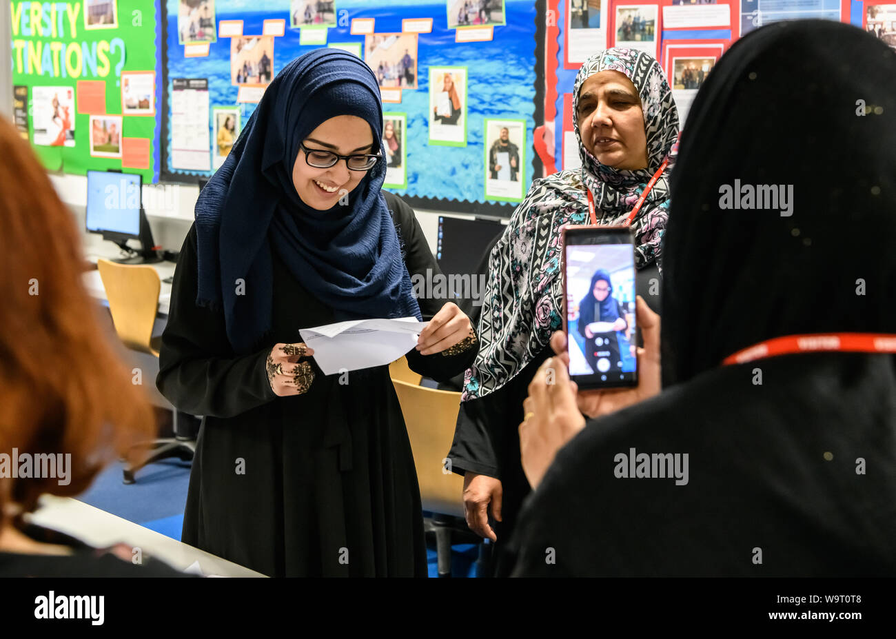 Birmingham, UK. 15th August 2019. A Level student Halima Bibi opens her A Level results and celebrates with family members at Ark St Alban's Academy in Birmingham. Halima is going to study pharmacy at Aston University. Credit: Simon Hadley/ Alamy Live News. Stock Photo