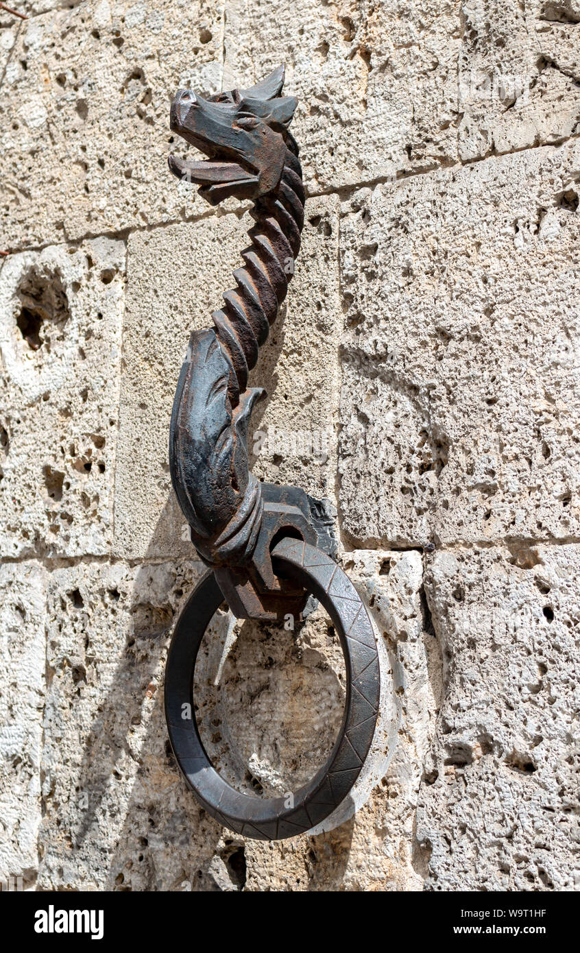Old metal horse hitching ring on a wall in Siena, Italy. Stock Photo