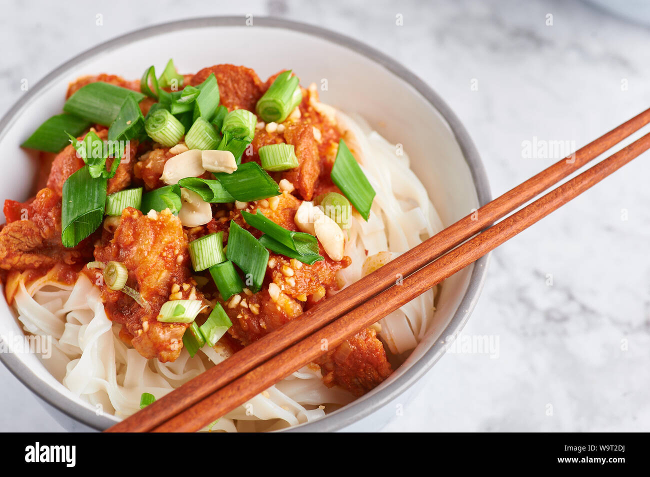 shan noodles with chopsticks at white marble tabletop. burmese cuisine