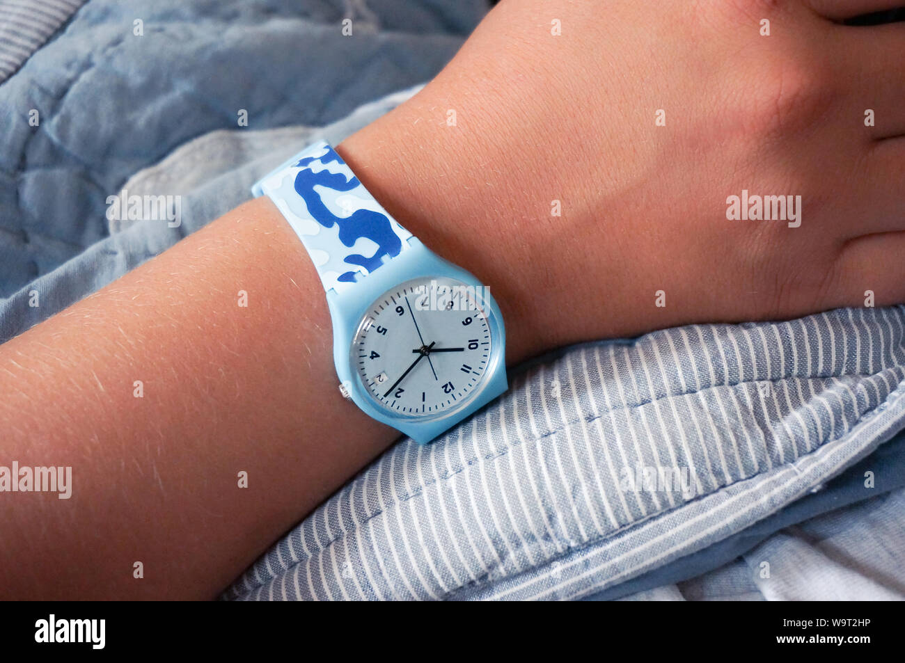 Alicante, Spain - August, 2019: Blue rubber Swatch watch on wrist Stock Photo