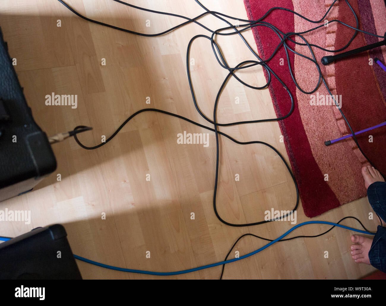 Guitar leads and amplifiers on a floor during a band rehearsal. Stock Photo