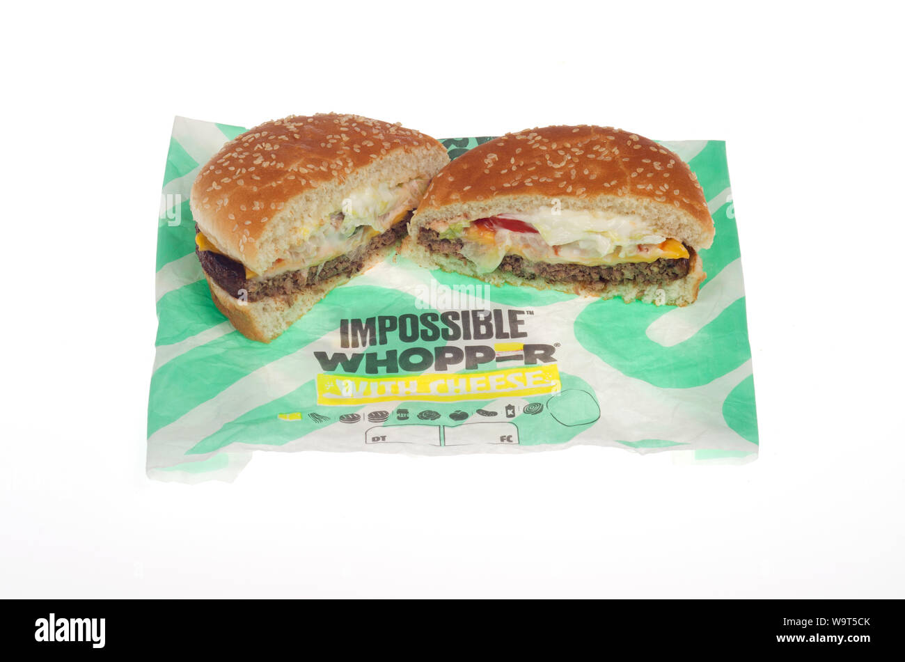 Burger King Impossible Whopper with cheese cut in half on wrapper