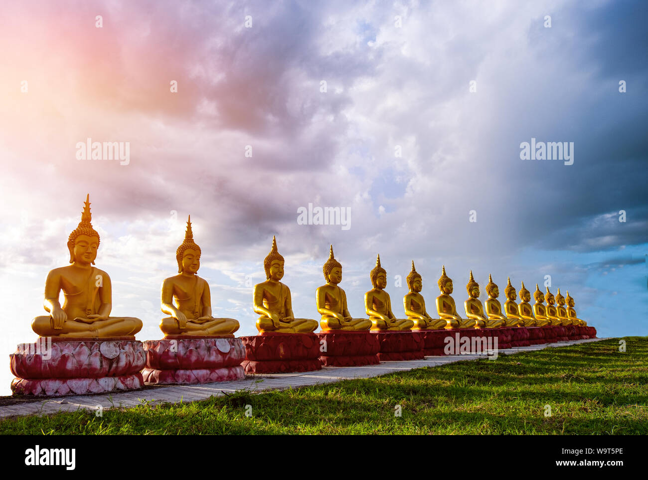 Buddha statue in temple at sun sky and cloud background Stock Photo - Alamy