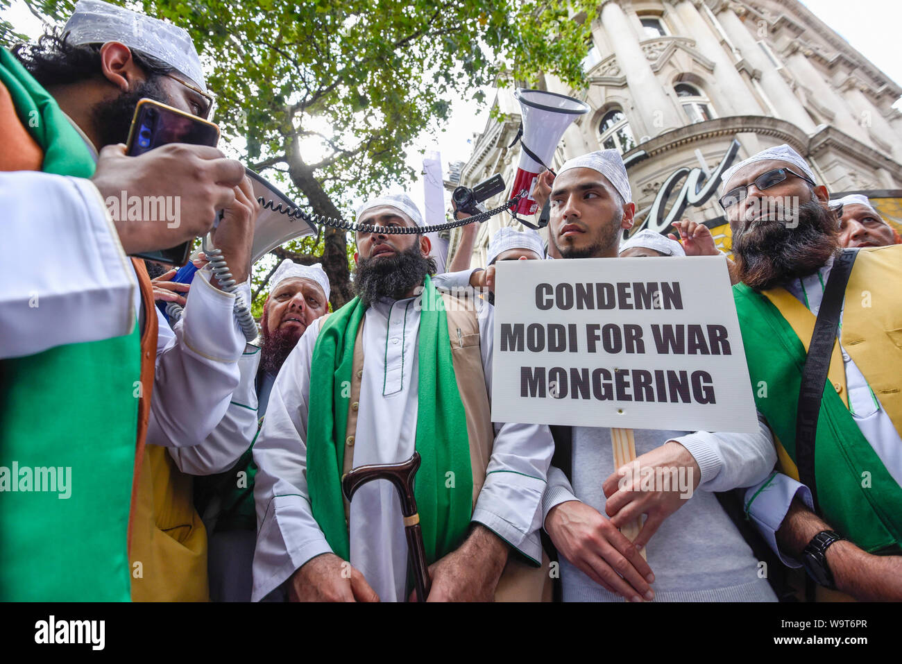 London, UK.  15 August 2019.  Muslim men join thousands of protesters, many waving Pakistani and Kashmiri flags, outside the Indian High Commission in Aldwych, on what they are calling Black Day, to stand in solidarity with the people of Kashmir.  Indian Prime Minister Narendra Modi delivered an Independence Day speech highlighting his decision to remove the special rights of Kashmir as an autonomous region. Credit: Stephen Chung / Alamy Live News Stock Photo