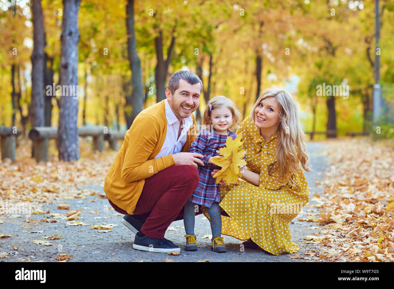 Family with daughter in the park in the fall. Stock Photo