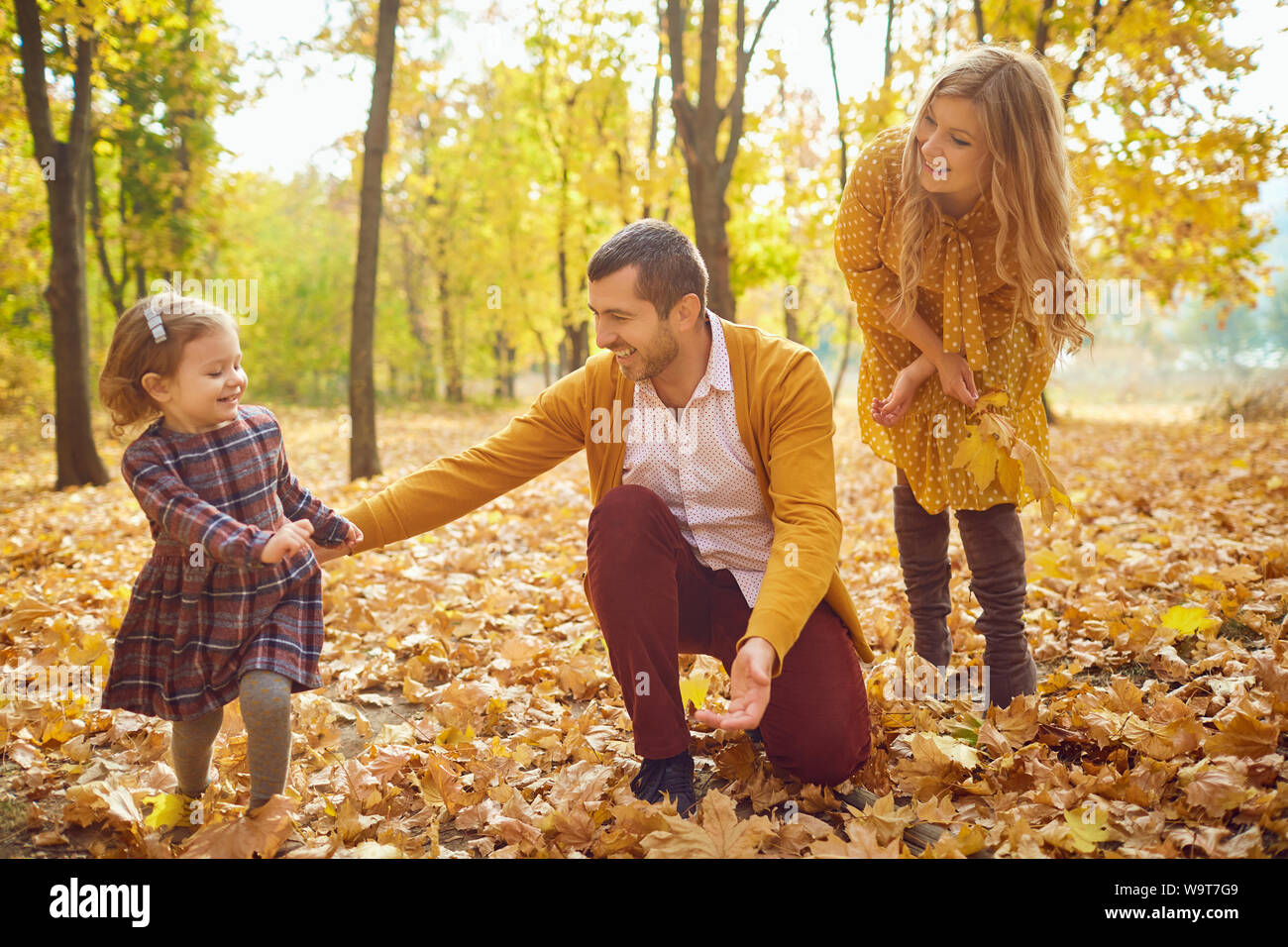 Family playing in the park in the fall. Stock Photo