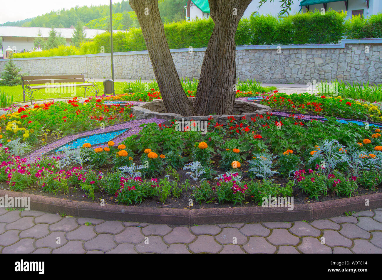 Round Flower Bed With Colorful Decorative Flowers And Plants
