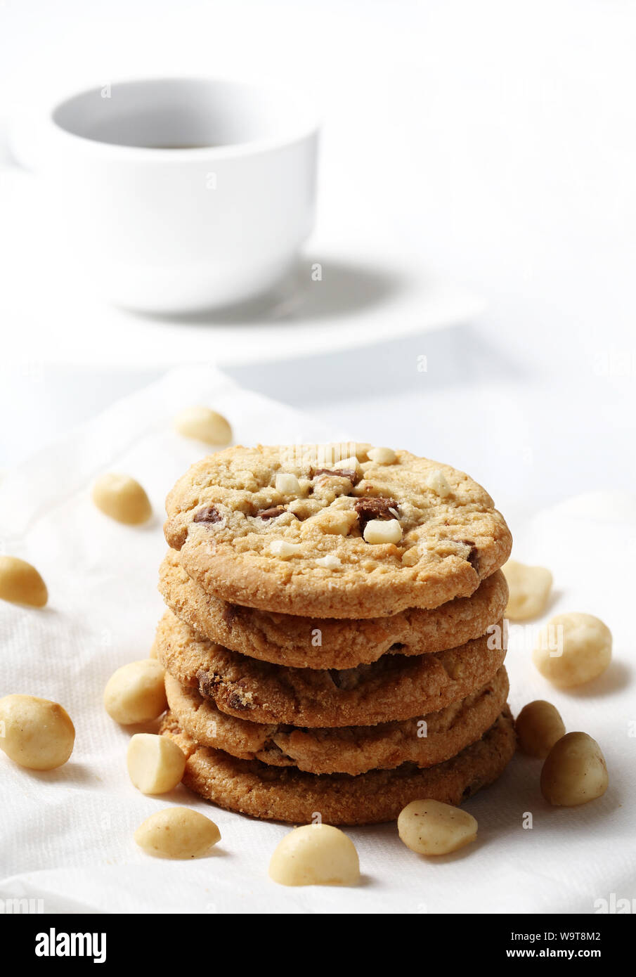 the chocolate chip and macadamia cookies on dish set for coffee break Stock Photo