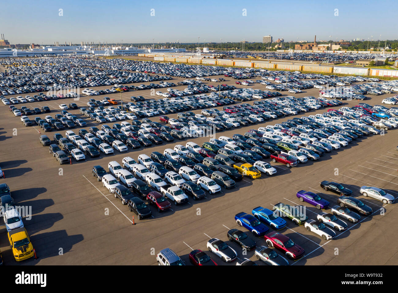 Detroit, Michigan - Trucks and cars built by Fiat Chrysler awaiting transport to dealers at FCA's Jefferson North Assembly Plant. Railroad auto carrie Stock Photo
