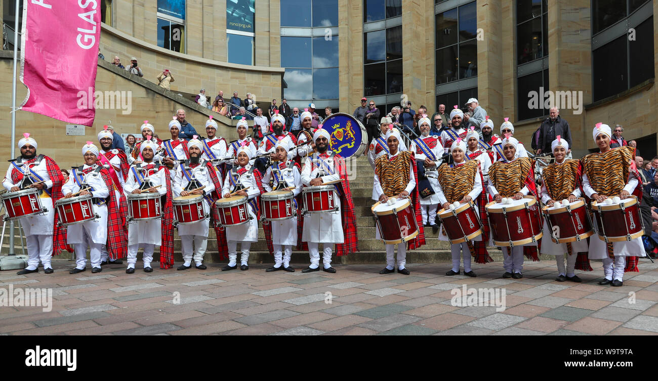 Glasgow, UK. 15 August 2019.  Piping Live, thought to be the biggest celebration of bagpipe music and pipe bands continues to attract large audiences and entertain with free performances in Buchanan Street in Glasgow's City Centre from international pipe bands. Sri Dasmesh Pipe band from Malaysia entertain. Credit: Findlay/Alamy Live News Stock Photo