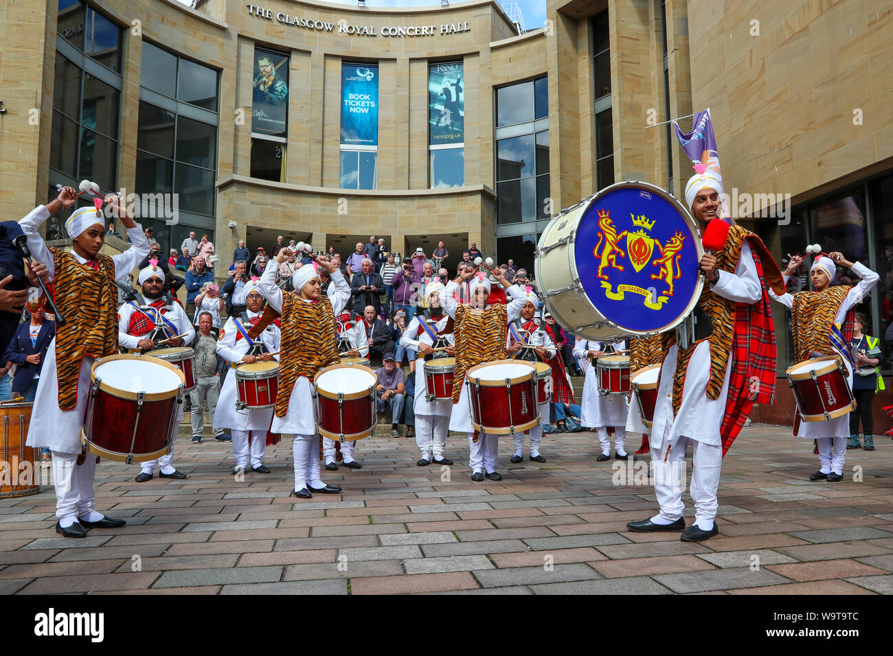 Glasgow, UK. 15 August 2019.  Piping Live, thought to be the biggest celebration of bagpipe music and pipe bands continues to attract large audiences and entertain with free performances in Buchanan Street in Glasgow's City Centre from international pipe bands. Sri Dasmesh Pipe band from Malaysia entertain. Credit: Findlay/Alamy Live News Stock Photo