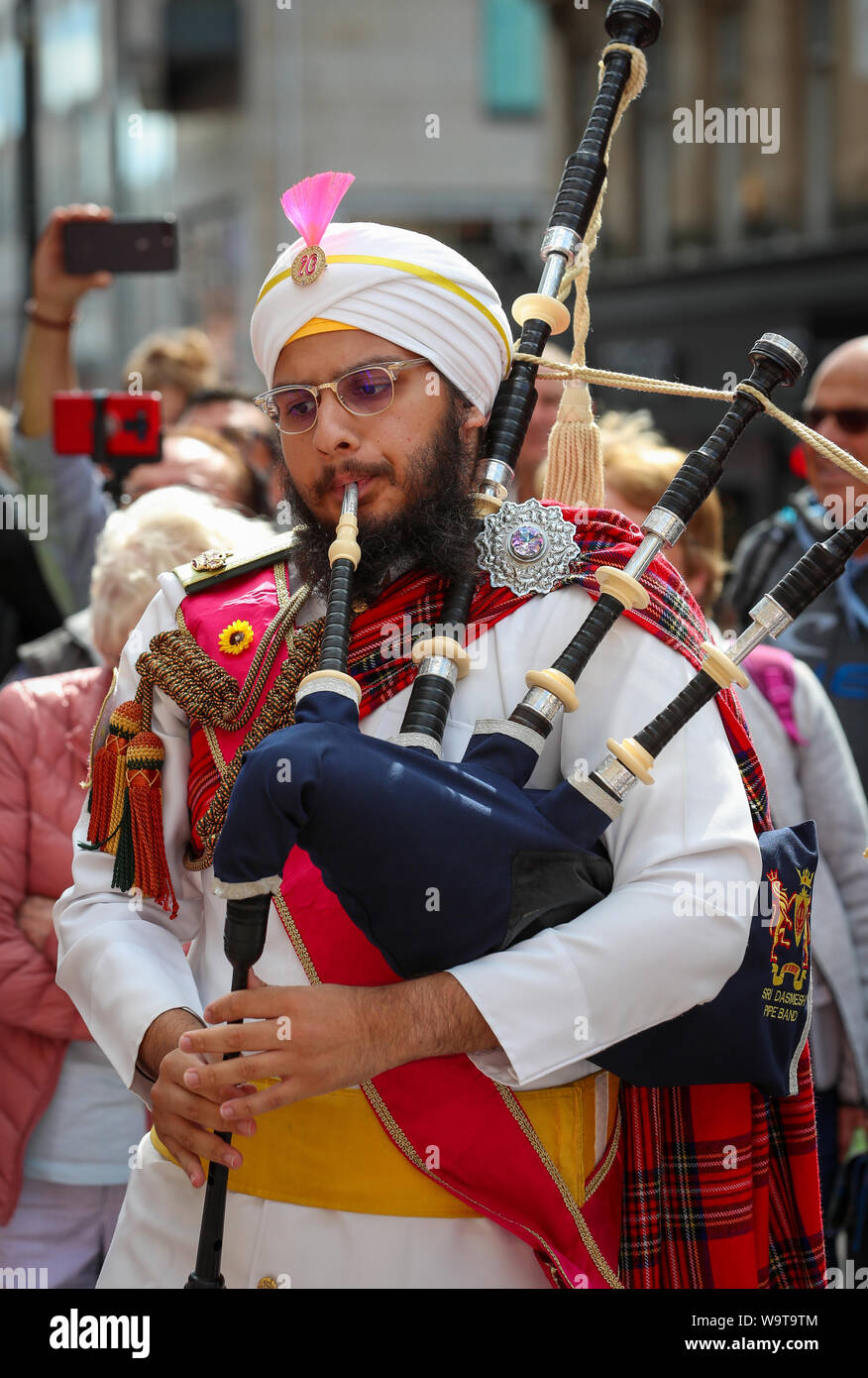 Glasgow, UK. 15 August 2019.  Piping Live, thought to be the biggest celebration of bagpipe music and pipe bands continues to attract large audiences and entertain with free performances in Buchanan Street in Glasgow's City Centre from international pipe bands. Sri Dasmesh Pipe band from Malaysia entertain. Credit: Findlay/Alamy Live News Stock Photo