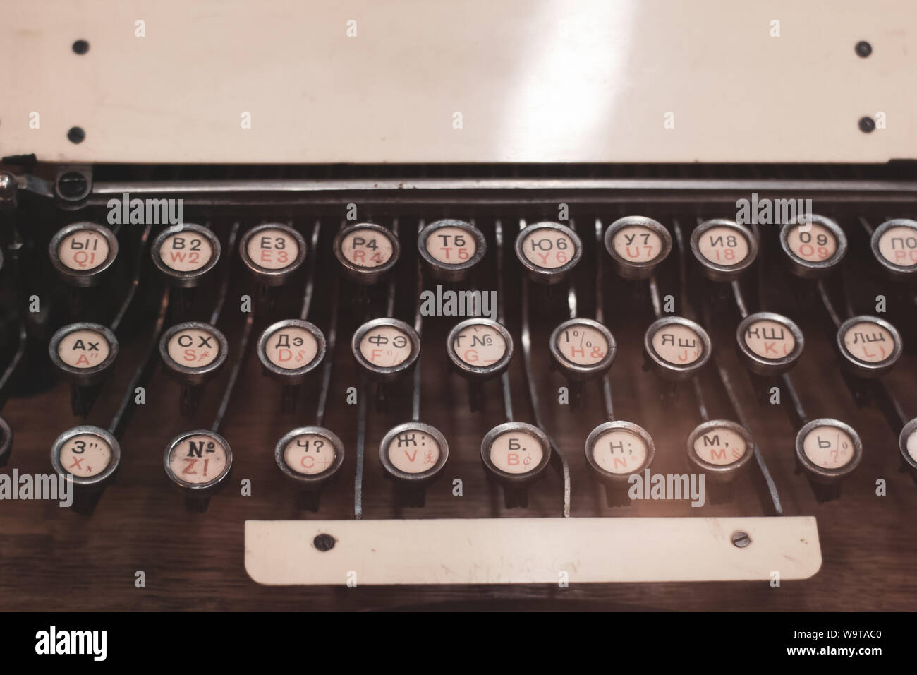 Keys of an old vintage american typewriter with russian and english alphabet closeup. Place for text. Stock Photo