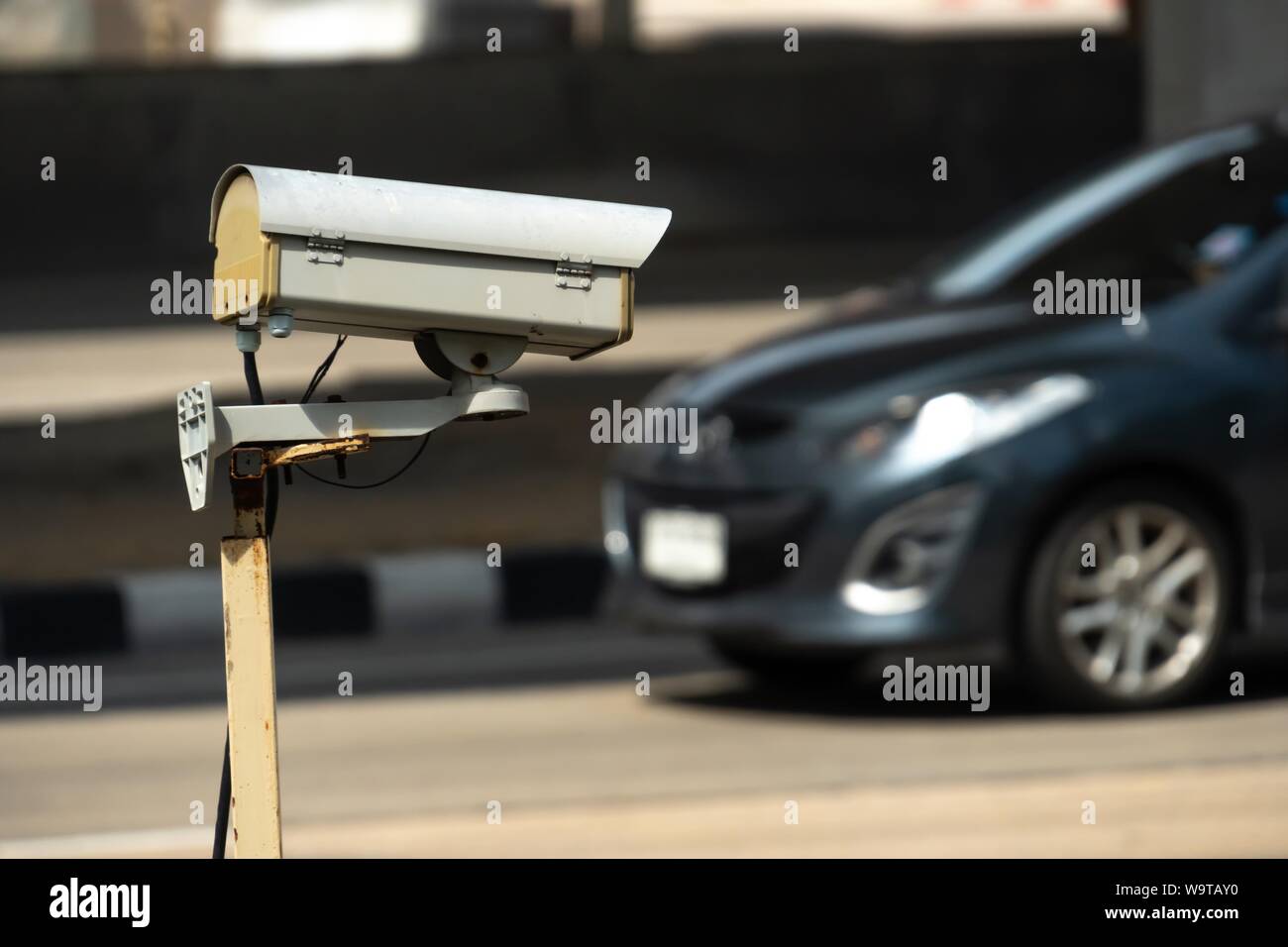 security monitoring CCTV camera mounted on old pole steel post. Stock Photo