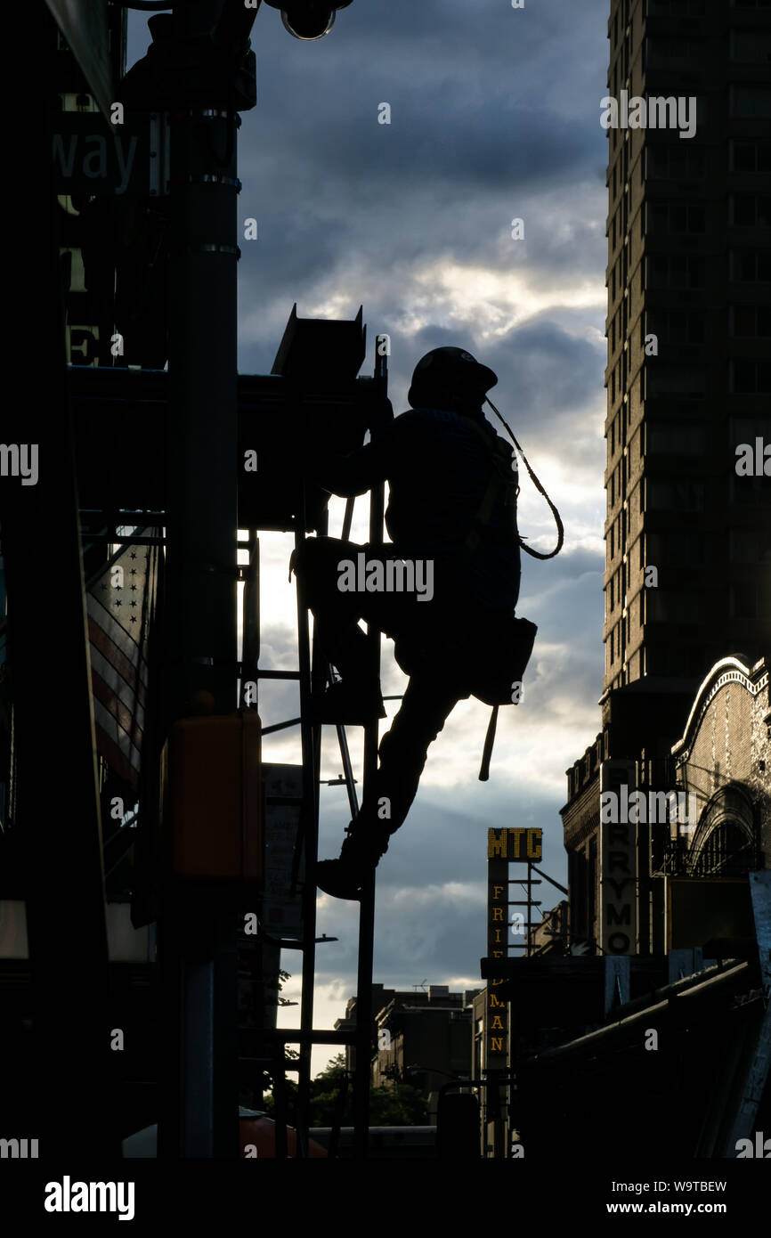 USA, America, NYC, New York, a worker working on a house facade, back light, climbing, Stock Photo
