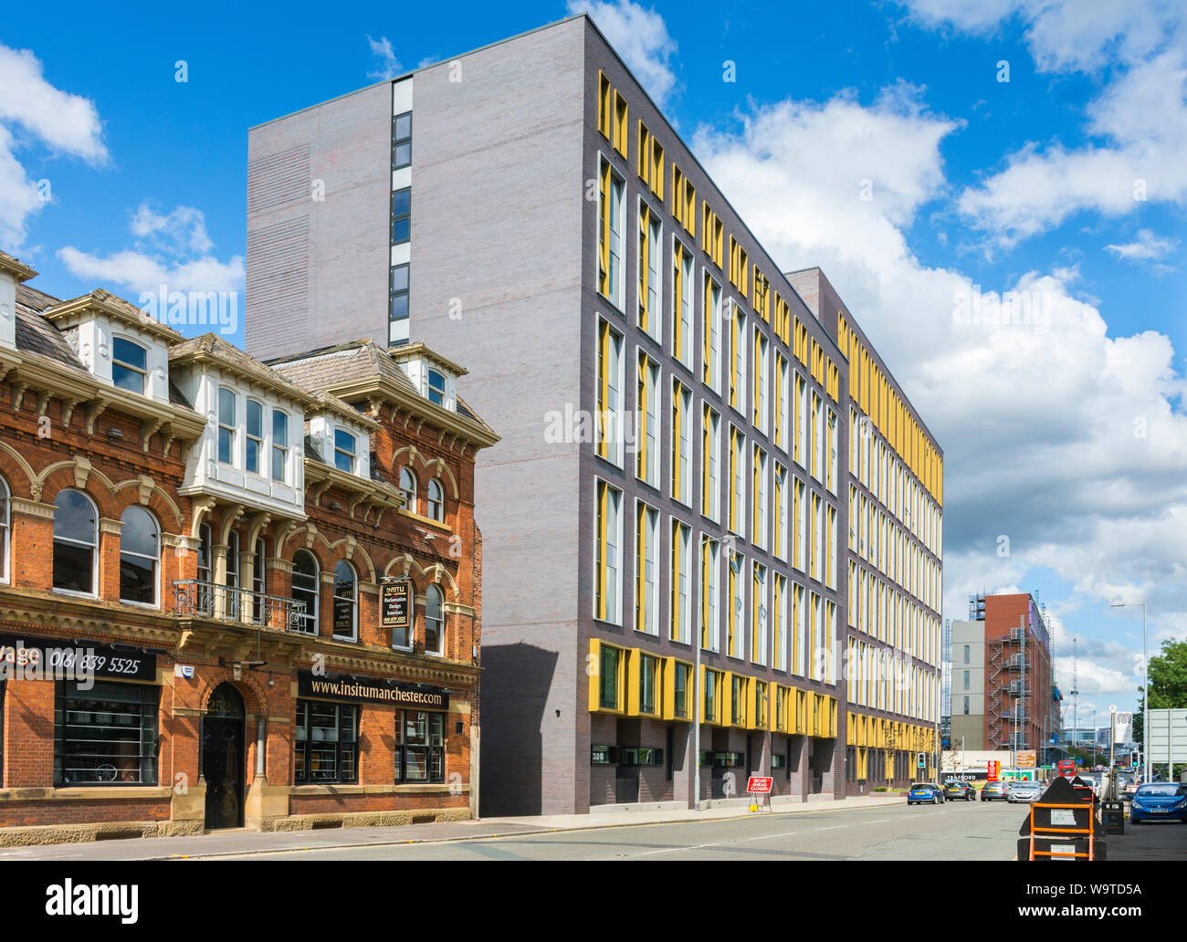 The Trilogy apartment block, Chester Road,  Manchester, England, UK. The Insitu architectural salvage shop, a former hotel and pub, at left. Stock Photo