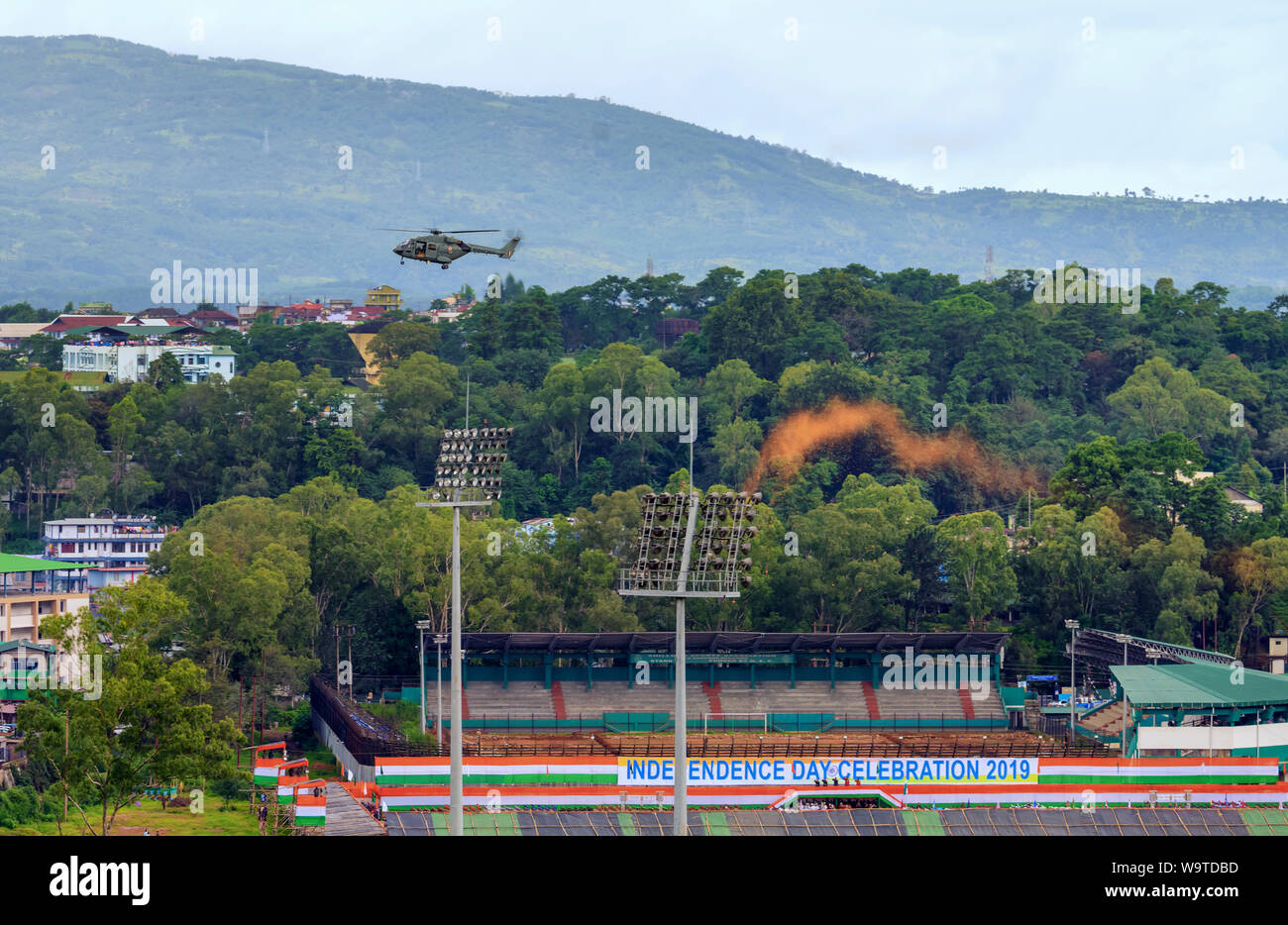 An Indian Air Force Dhruv helicopter flies away after dropping flower petals on people celebrating India's Independence Day, 15 August, 2019. Stock Photo