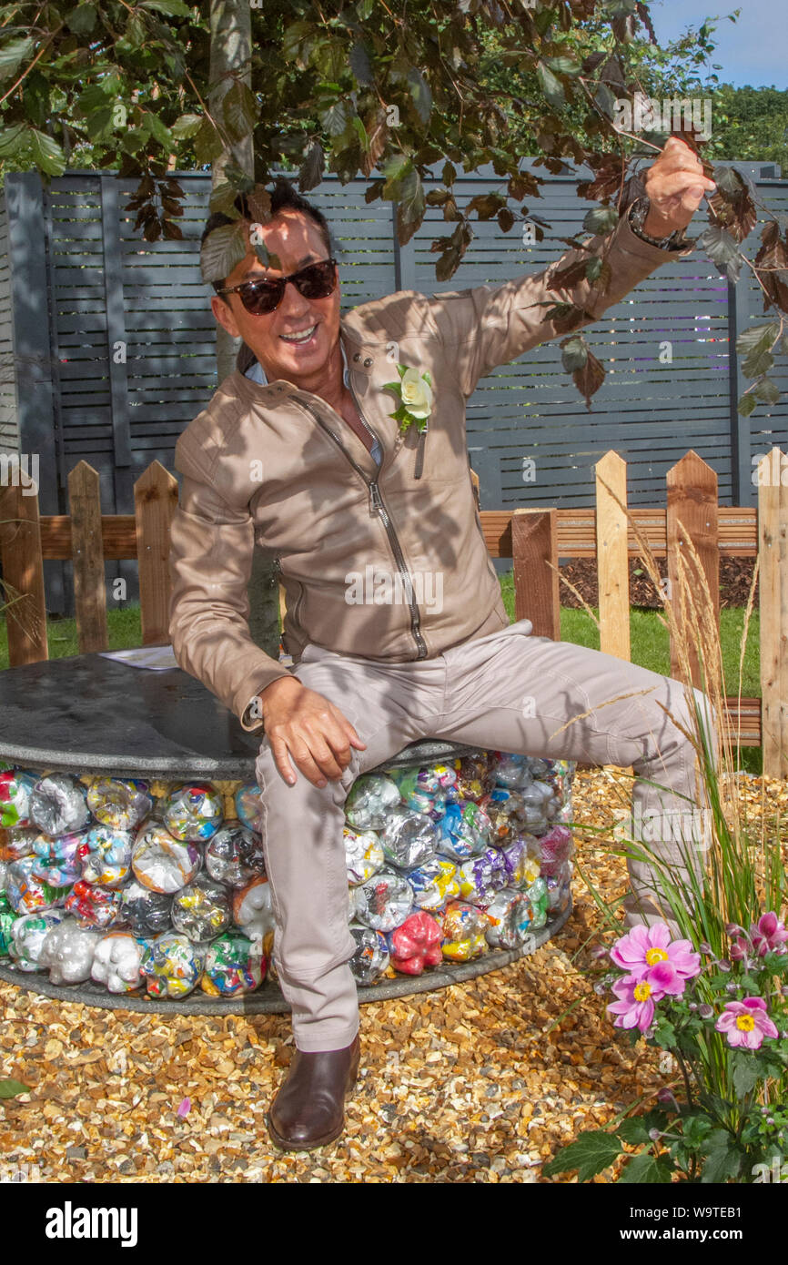 Strictly Come Dancing judge Bruno Tonioli Bruno Tonioli an Italian choreographer, ballroom and Latin dancer. The TV personality casts his critical eye over the show winning Gold Charity garden as he opens the 2019 Southport Flower Show in Merseyside.  The TV favourite welcomed visitors to the event as it celebrates its 90th anniversary this week with a giant garden party seated on an upcycled reused plastic tree seat. Stock Photo
