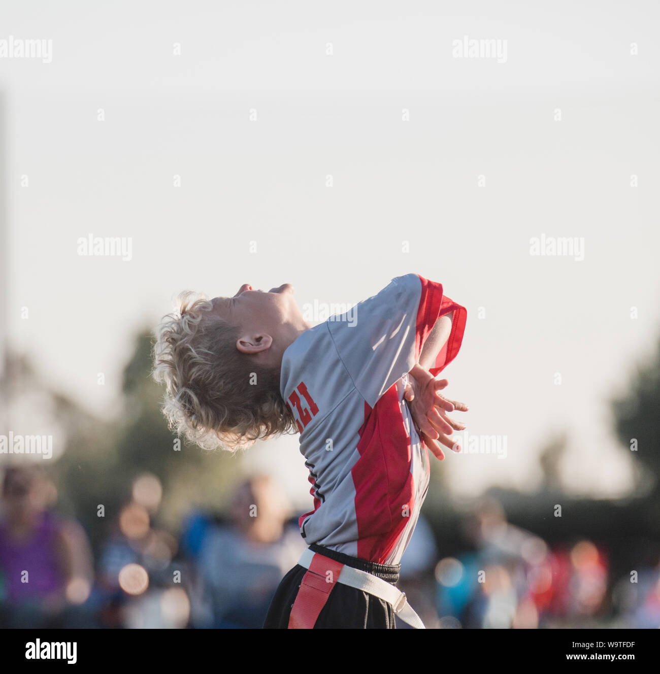 Boy playing flag football celebrating, California, United States Stock Photo