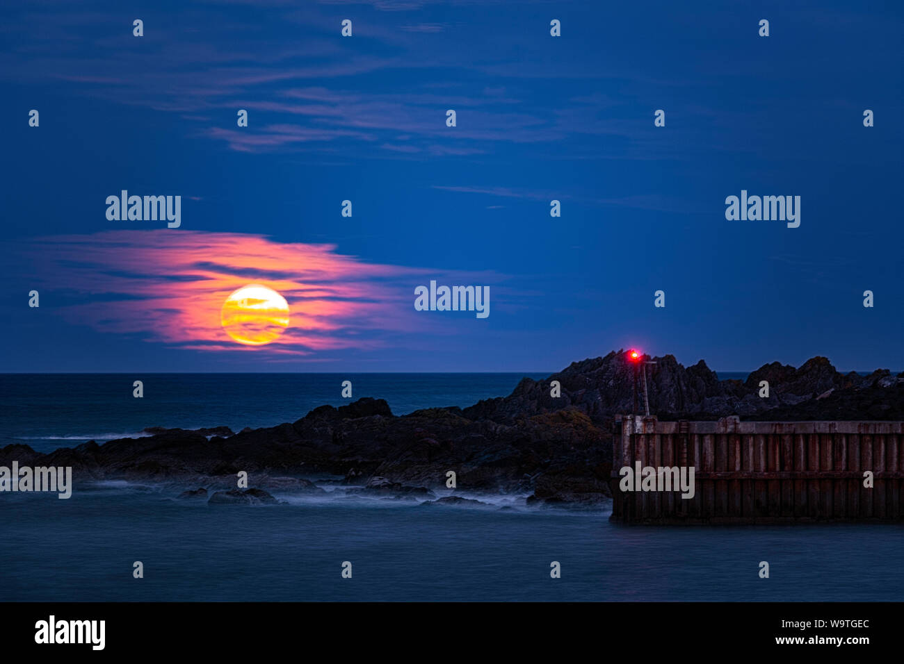 The Hunters Moon rising over Eyemouth Stock Photo