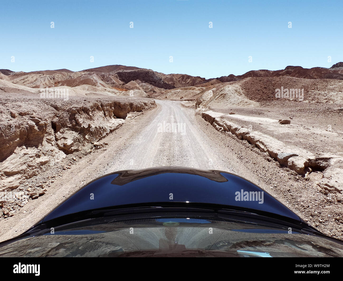 Car driving along a desert road, Death Valley National Park, Nevada, United States Stock Photo