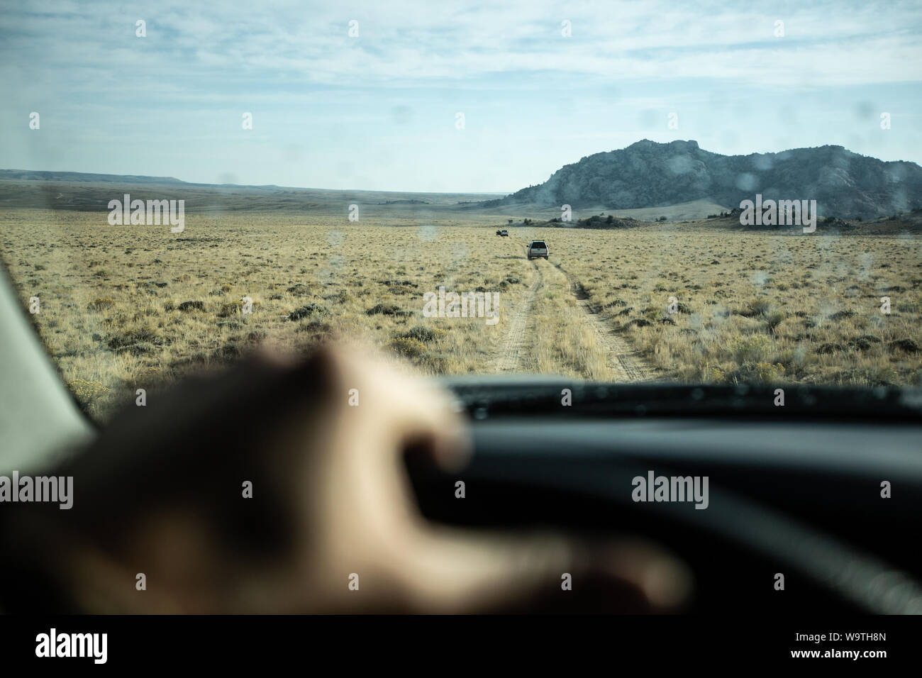 One person driving through a desert landscape, United States Stock Photo