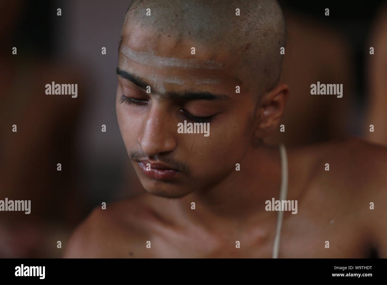 Kathmandu, Nepal.15 Aug, 2019. Young Nepalese Hindu priest owrship during the Janai Purnima Festival at Pashupatinath Temple. Sarita Khadka/Alamy Live News Stock Photo