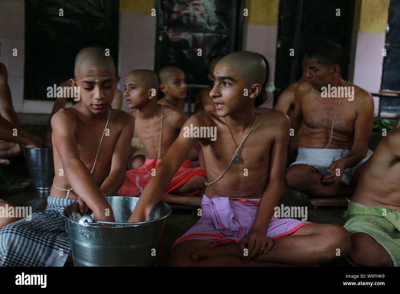 Kathmandu, Nepal.15 Aug, 2019. Young Nepalese Hindu priest owrship during the Janai Purnima Festival at Pashupatinath Temple. Sarita Khadka/Alamy Live News Stock Photo