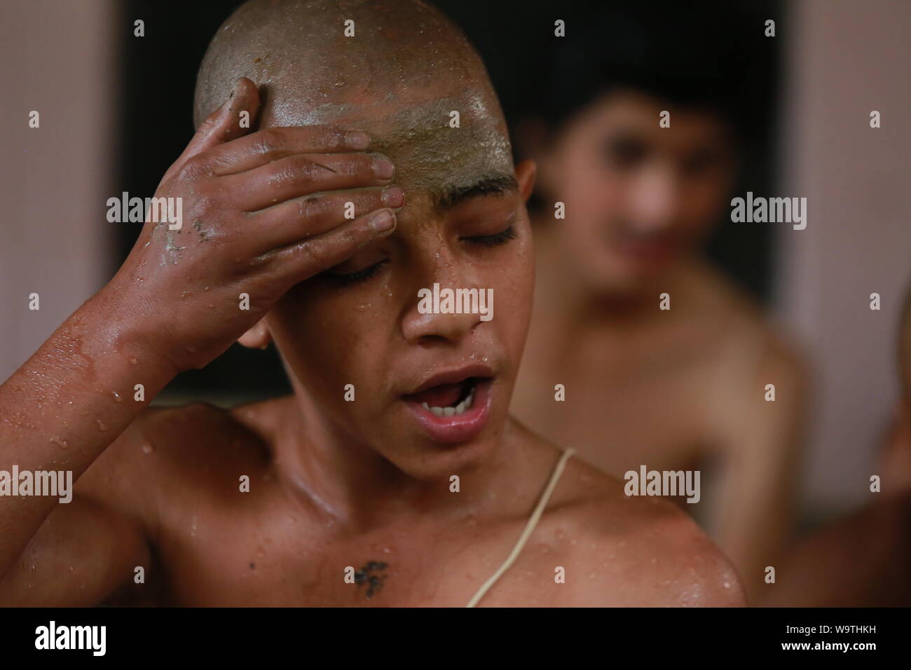 Kathmandu, Nepal.15 Aug, 2019. Young Nepalese Hindu priest take a holy bath and prayers during the Janai Purnima Festival at Pashupatinath Temple. Sarita Khadka/Alamy Live News Stock Photo