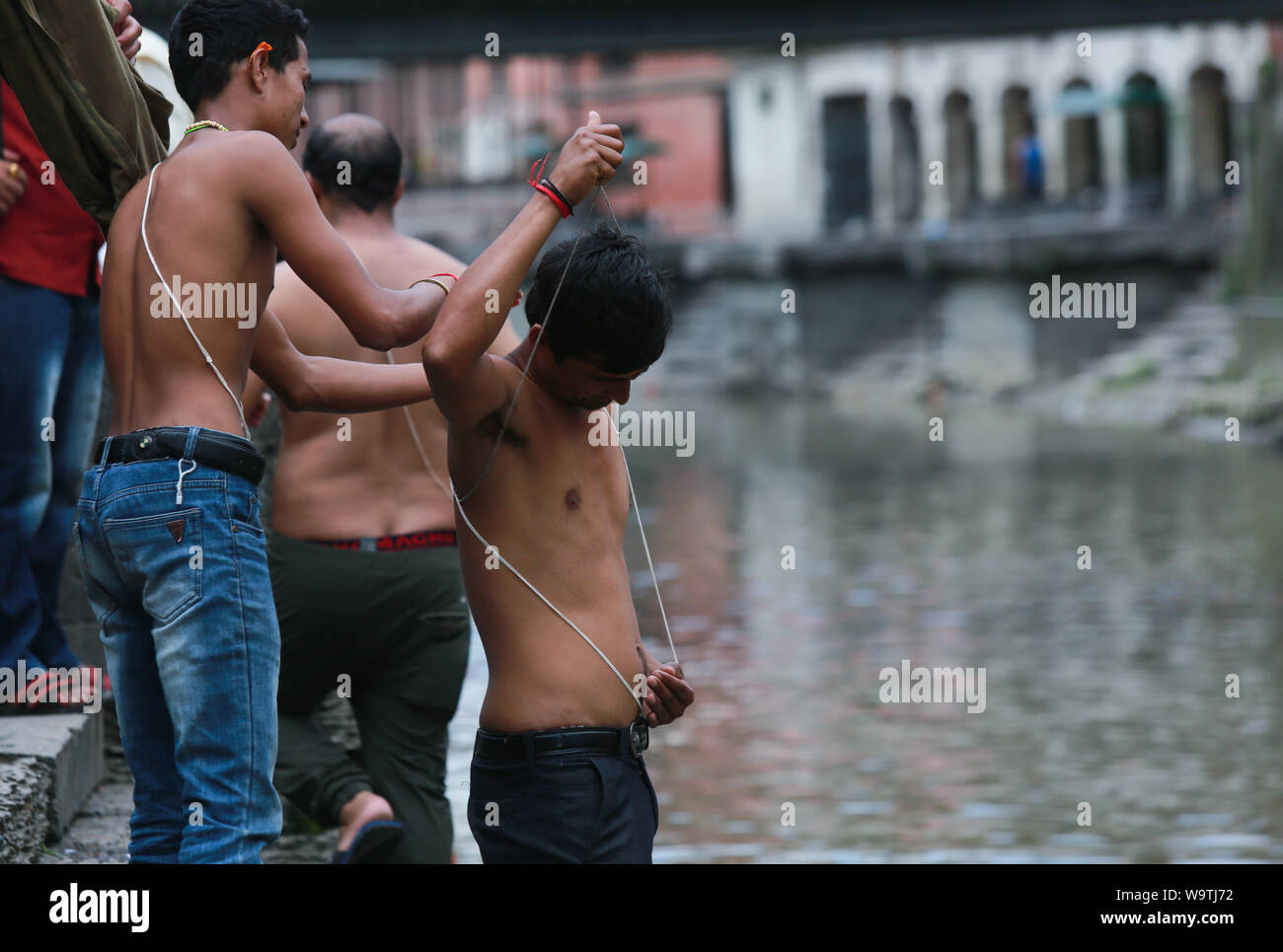 Kathmandu, Nepal. 15 August, Changing a Janai  (a sacred thread). Sarita Khadka/Alamy Live News Stock Photo