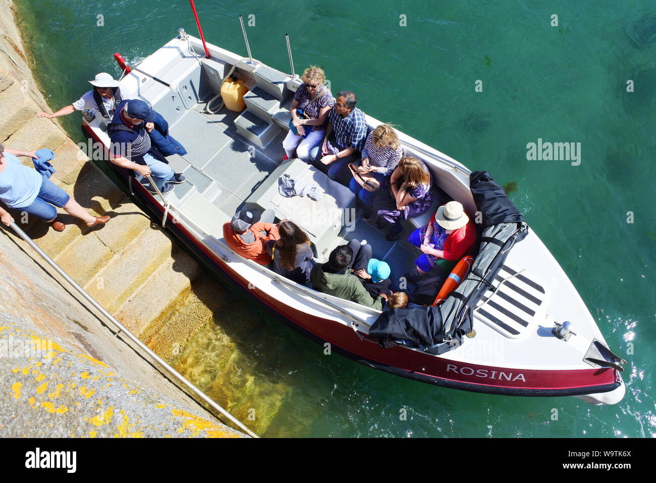 Tourists boarding a small ferry after visiting St. Michael's Mount