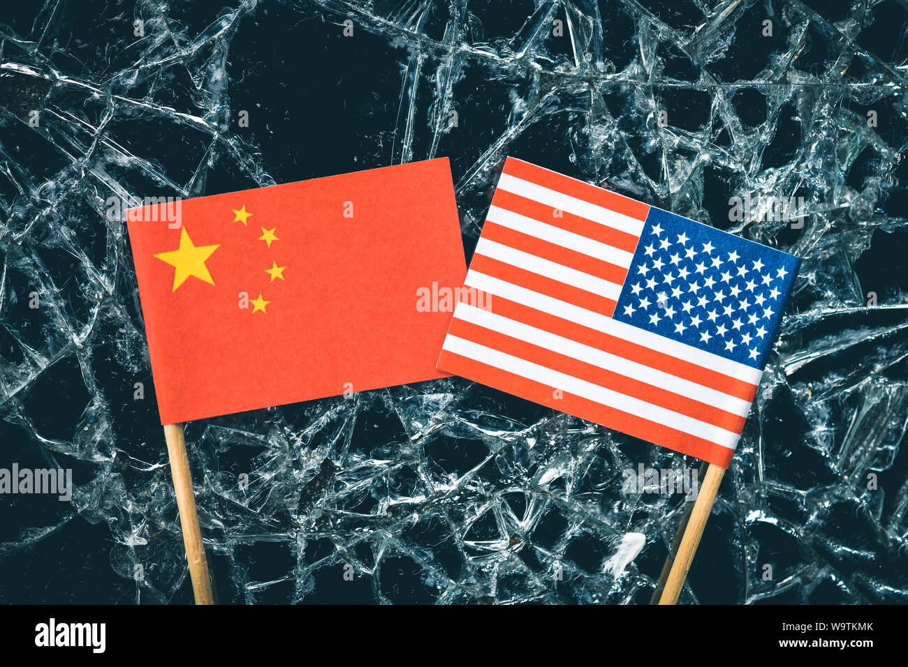 Flags of the USA and China on broken glass, trade war Stock Photo