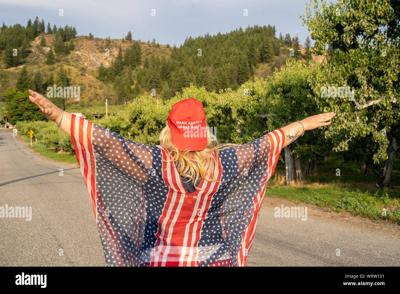 Wenatchee, Washington - July 4, 2019: Republican woman wearing a MAGA hat (Make America Great Again) supporting President Donald Trump and his 2020 re Stock Photo